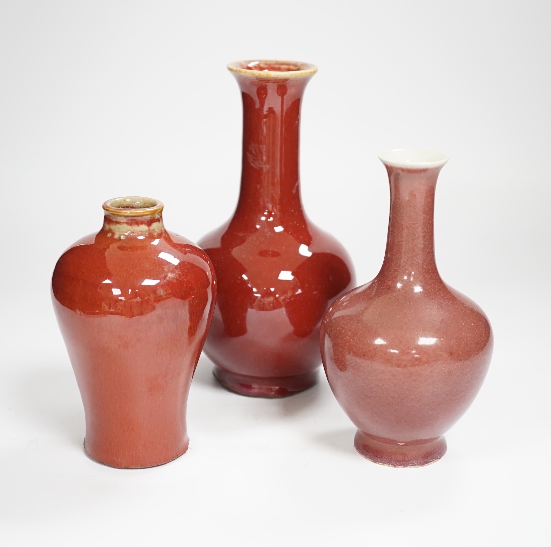 Three Chinese sang de boeuf glazed vases, largest 18cm high